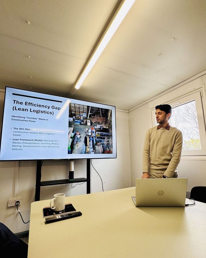 Muhammad presenting a slide on lean logistics and waste in construction flows.
