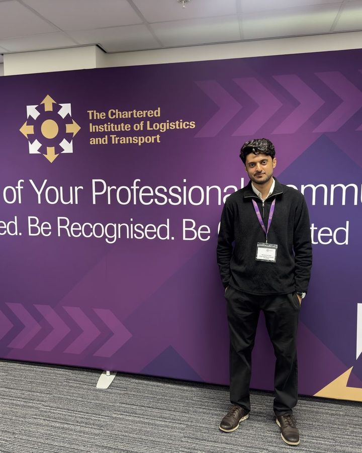 Muhammad in front of a Chartered Institute of Logistics and Transport banner.