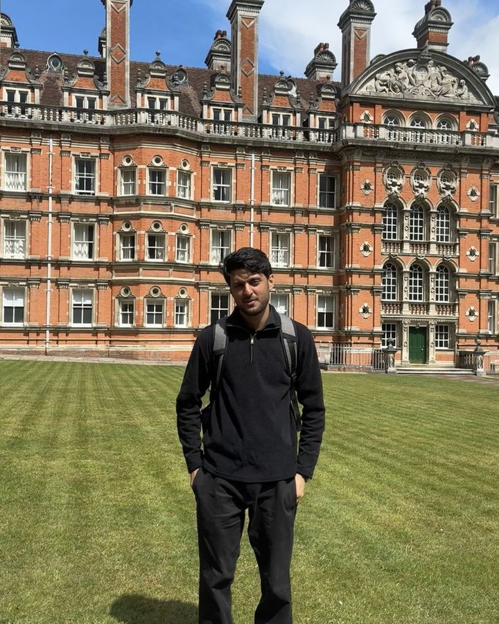 Muhammad on the lawn in front of the Founder's Building at Royal Holloway, Egham.